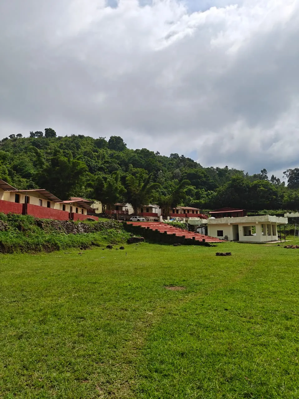 Vistara Resort cottages and open green lawn